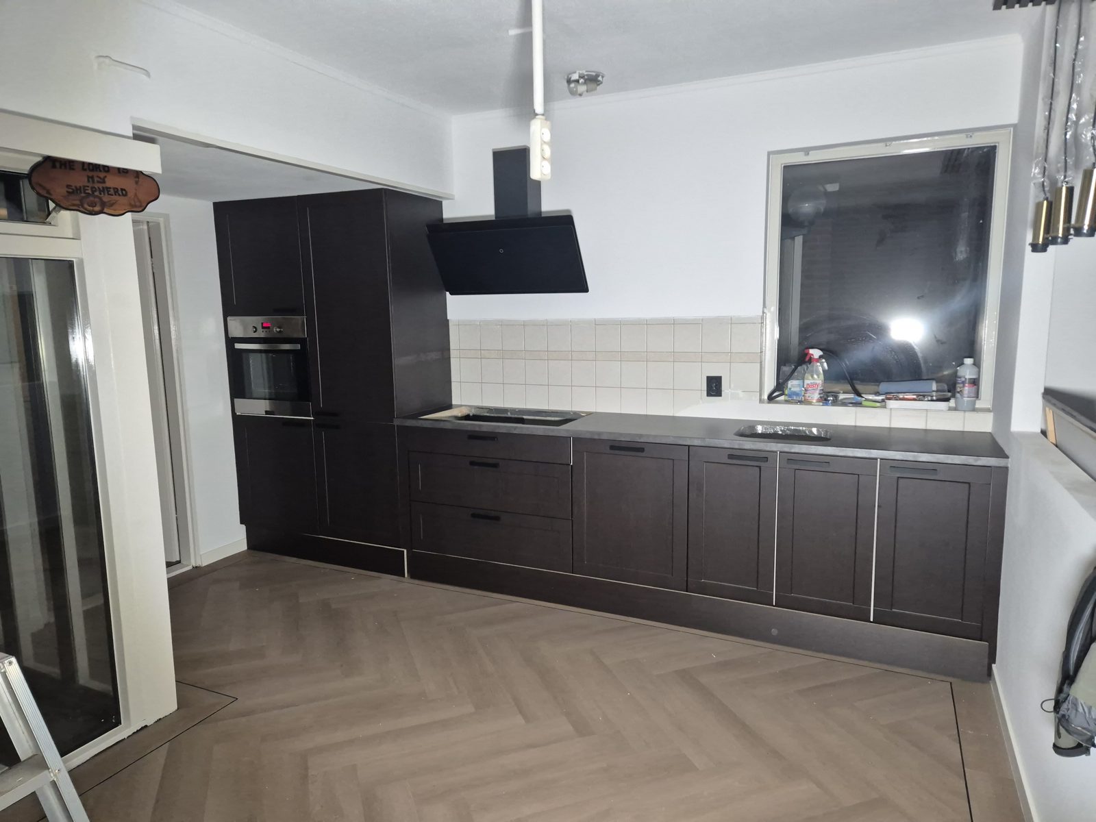 Dezelfde keuken na het wrappen in Bodaq LW120 Ebony Oak met betonlook werkblad, Deventer